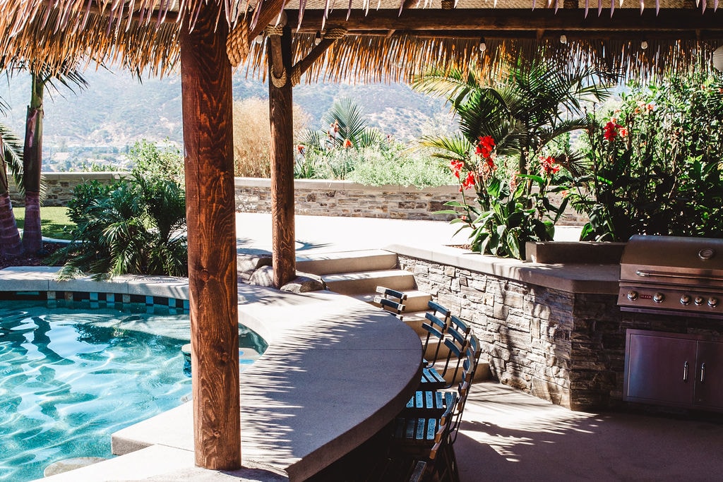 Outdoor kitchen and pool with palapa in San Diego