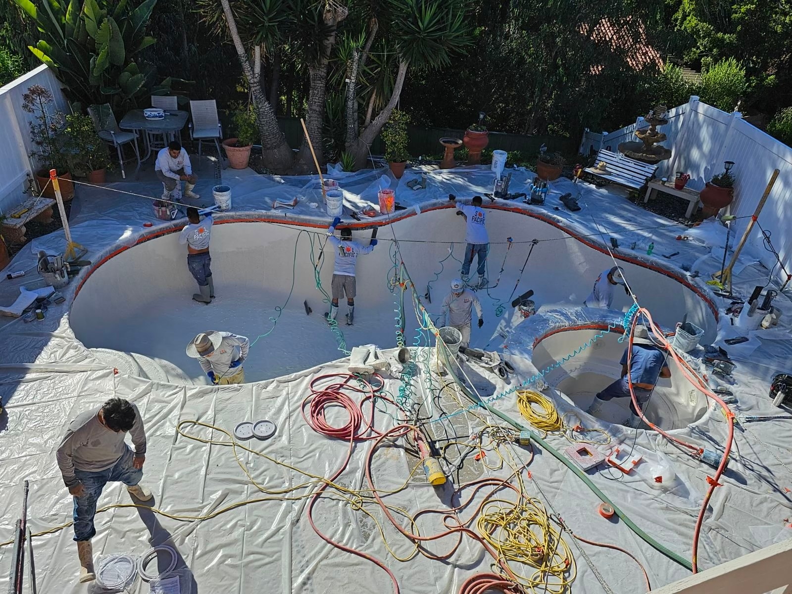 Sol Pacific Pool Plastering crew applying plaster to a residential pool in San Diego County
