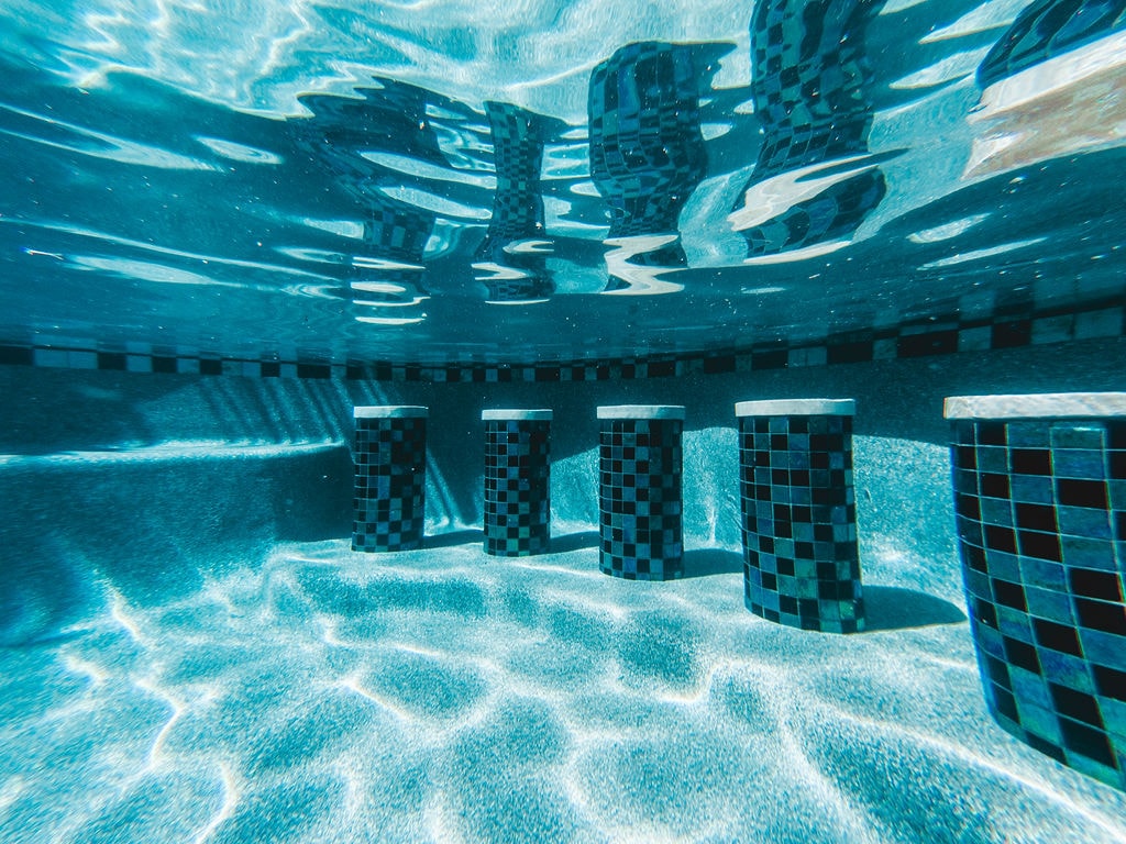 Underwater view of a freshly plastered pool with mosaic tile
